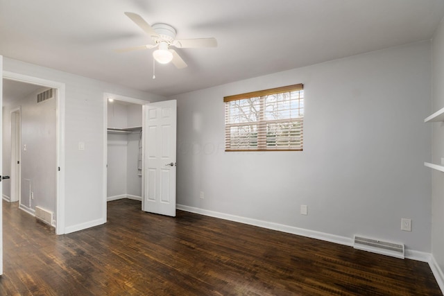 unfurnished bedroom featuring visible vents, baseboards, and wood finished floors