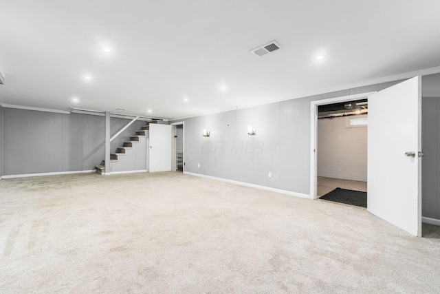 finished below grade area featuring carpet floors, crown molding, recessed lighting, visible vents, and stairway