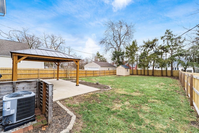 view of yard with a patio, cooling unit, an outdoor structure, a gazebo, and a storage unit