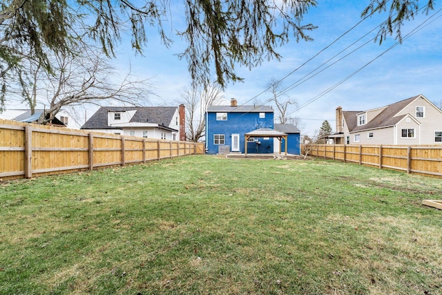 view of yard featuring a fenced backyard and a gazebo