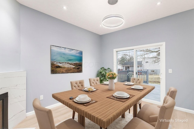 dining room with recessed lighting, light wood-type flooring, and baseboards