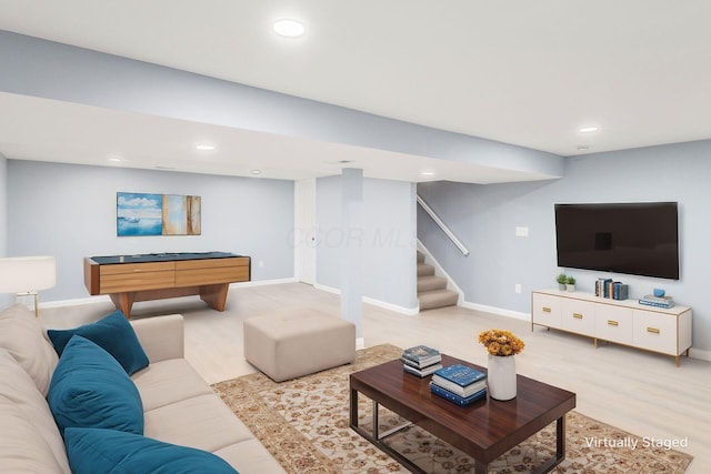 living area with baseboards, stairway, wood finished floors, and recessed lighting