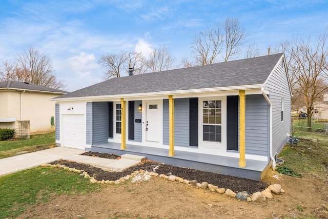 ranch-style house with an attached garage, covered porch, fence, driveway, and roof with shingles