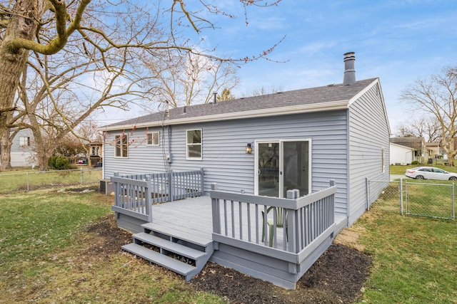 rear view of property with a gate, fence, a deck, and a yard