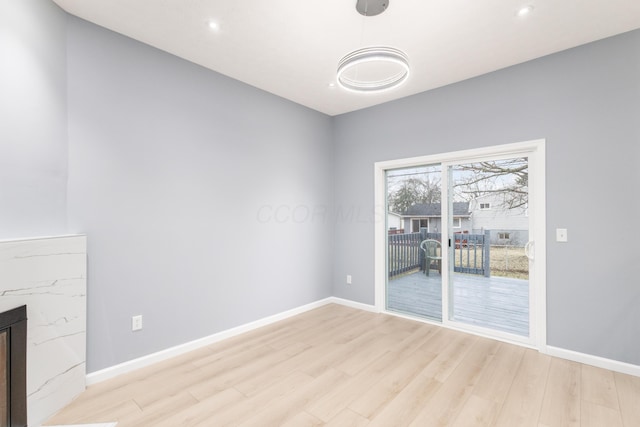 unfurnished living room featuring light wood-style flooring, baseboards, and recessed lighting