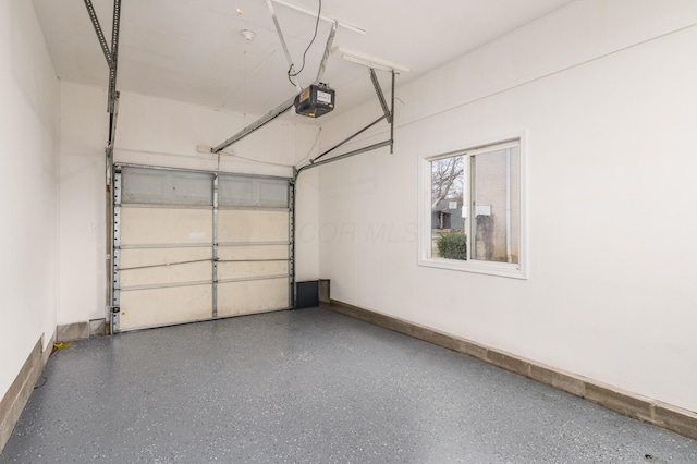 garage with a garage door opener and baseboards