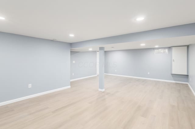 finished basement with light wood finished floors, baseboards, and recessed lighting