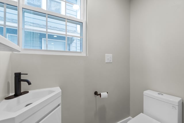 bathroom featuring toilet and vanity