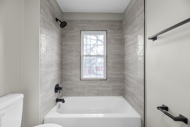 bathroom with bathing tub / shower combination and toilet