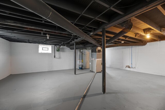 basement featuring heating unit and gas water heater