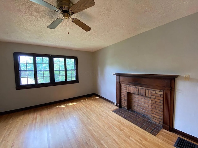 unfurnished living room featuring visible vents, baseboards, and wood finished floors