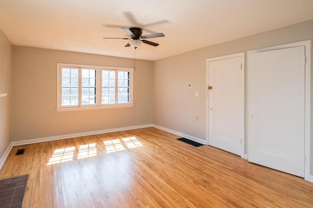 unfurnished bedroom with visible vents, baseboards, and light wood-style flooring