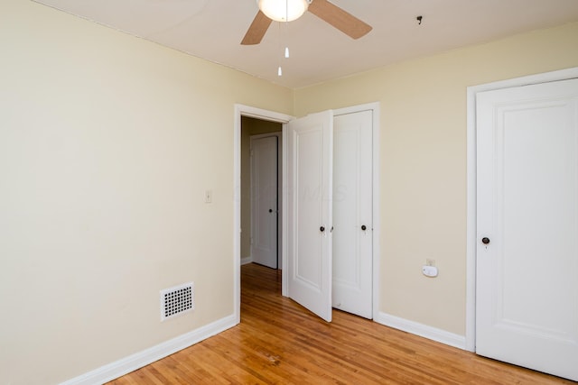 unfurnished bedroom featuring visible vents, baseboards, light wood-style floors, and ceiling fan