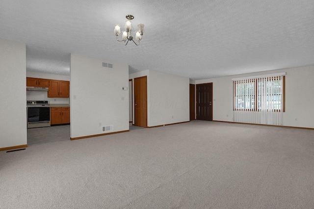 unfurnished living room with visible vents, light colored carpet, baseboards, and an inviting chandelier