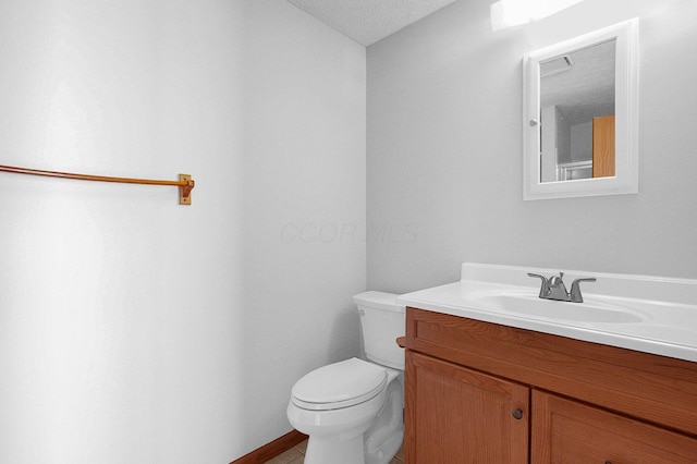 half bathroom with vanity and toilet