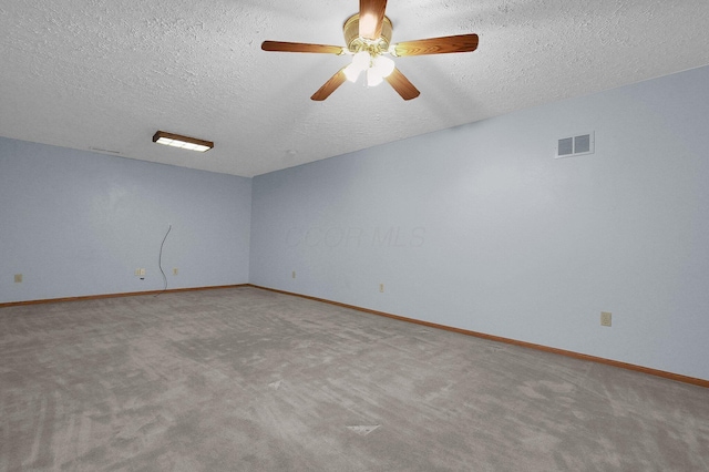 carpeted empty room featuring visible vents, baseboards, and a textured ceiling