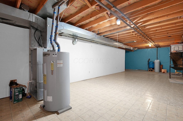 unfinished basement with tile patterned floors and electric water heater