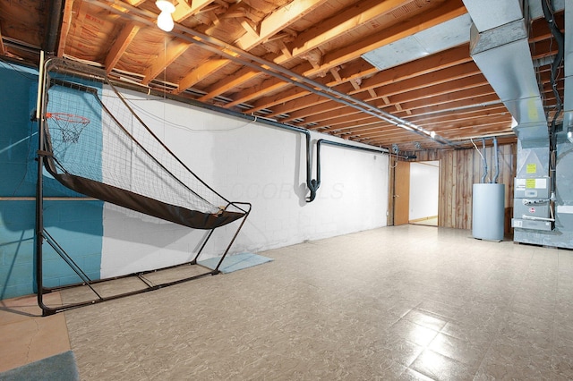 unfinished below grade area featuring gas water heater, heating unit, concrete block wall, and tile patterned floors