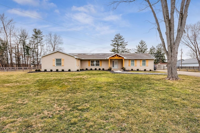 ranch-style home with a front yard and fence