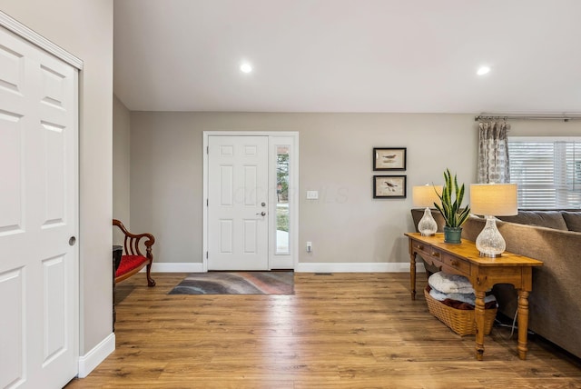 foyer entrance featuring recessed lighting, wood finished floors, and baseboards