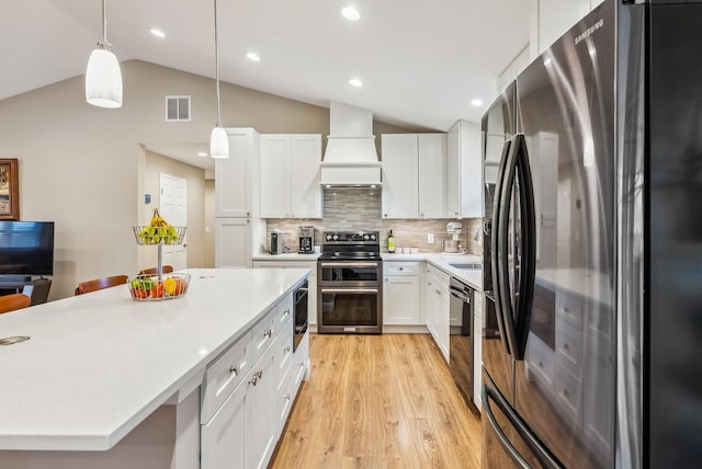 kitchen featuring visible vents, light wood-style floors, light countertops, appliances with stainless steel finishes, and custom exhaust hood