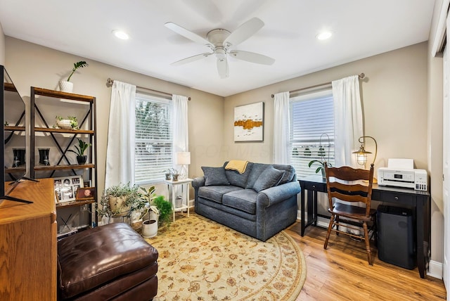 living area with a ceiling fan, recessed lighting, and wood finished floors