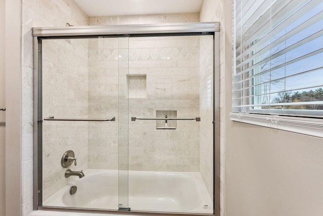 bathroom featuring shower / bath combination with glass door