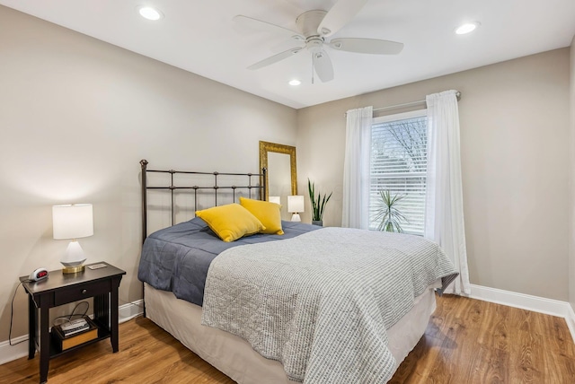 bedroom with recessed lighting, baseboards, and wood finished floors