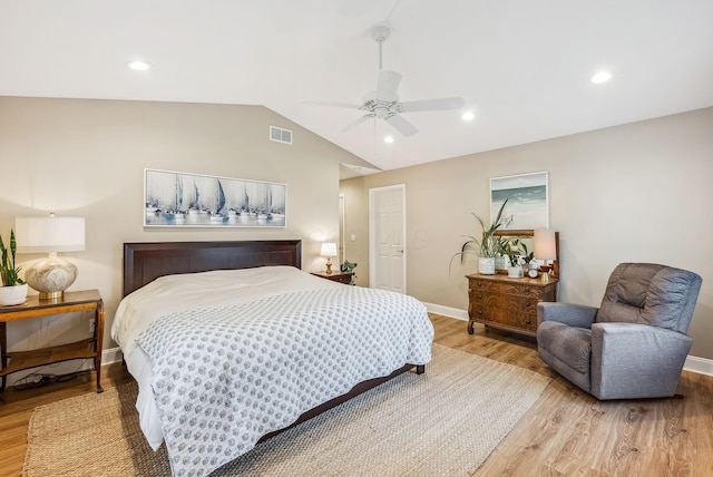 bedroom featuring visible vents, vaulted ceiling, ceiling fan, light wood-type flooring, and baseboards