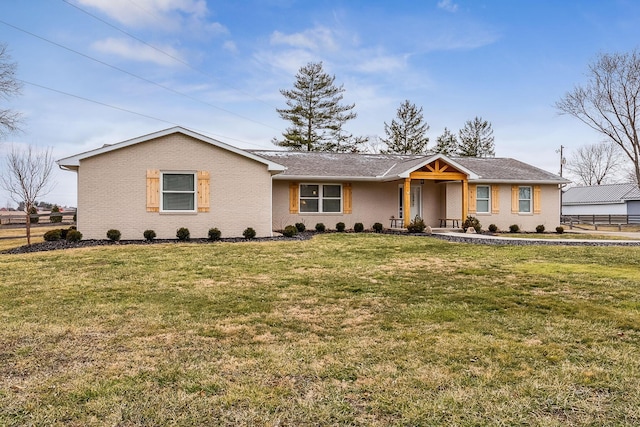 ranch-style house featuring a front lawn and fence