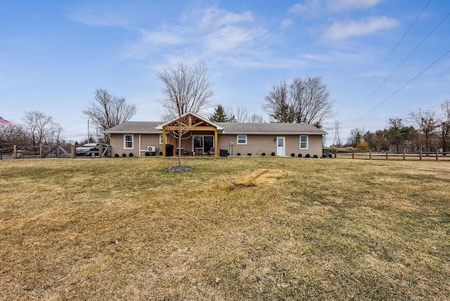 back of house with a yard and fence