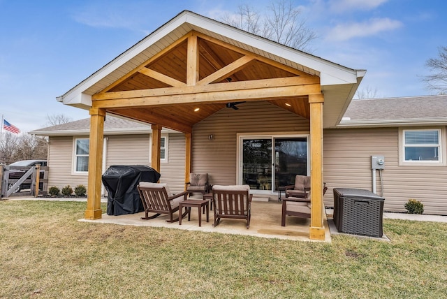 rear view of house featuring a patio area, ceiling fan, outdoor lounge area, and a lawn