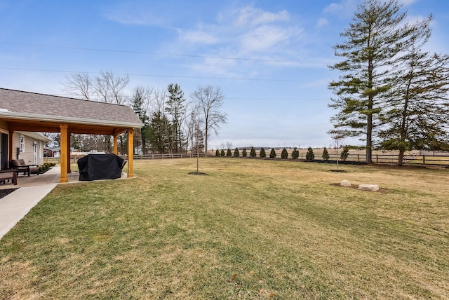 view of yard with fence and a patio