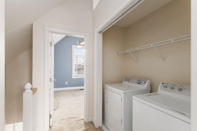 clothes washing area featuring baseboards, laundry area, washing machine and dryer, and light colored carpet