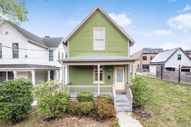 view of front of house with covered porch and fence