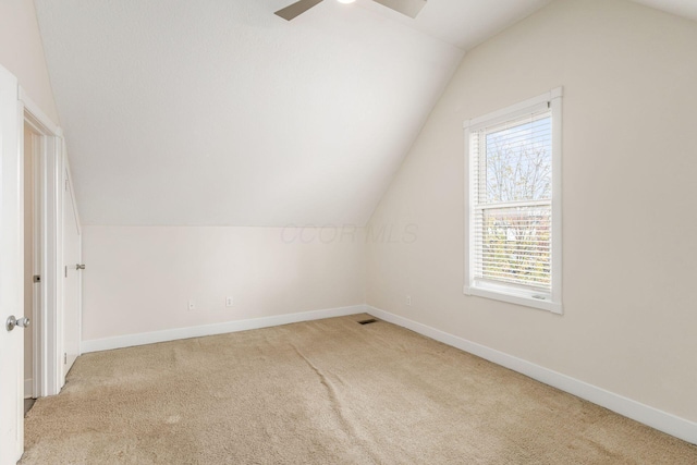 bonus room featuring carpet floors, vaulted ceiling, and baseboards