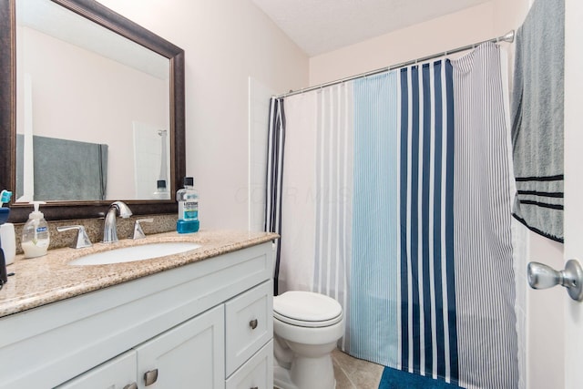 full bathroom featuring a shower with shower curtain, toilet, a textured ceiling, vanity, and tile patterned floors