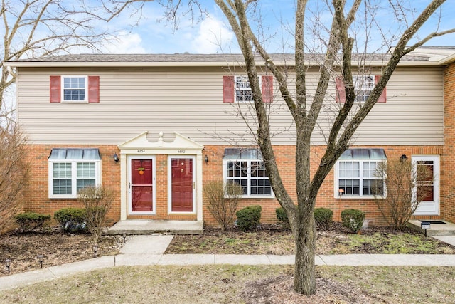 townhome / multi-family property with brick siding