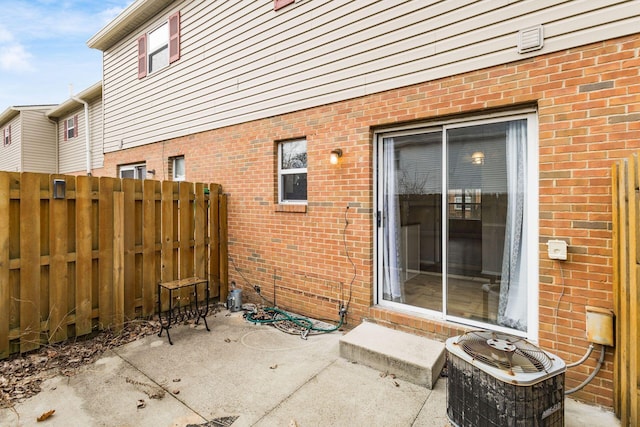 view of patio with cooling unit and fence