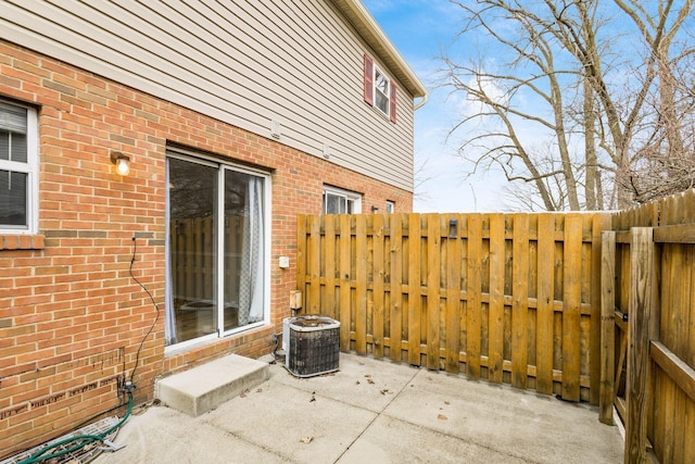 view of patio with fence and central AC