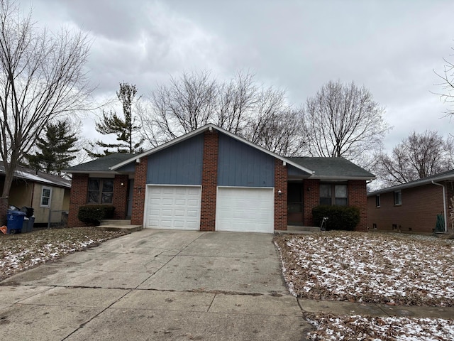 ranch-style home with a garage, brick siding, and concrete driveway