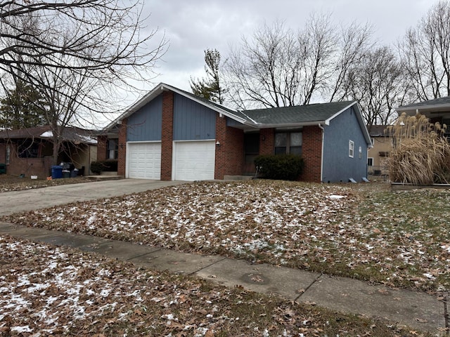 view of front of home with a garage, brick siding, and concrete driveway