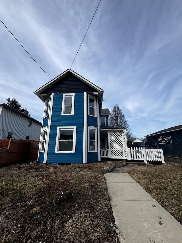 view of front of home featuring fence