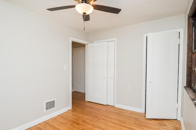 unfurnished bedroom with light wood-style flooring, baseboards, visible vents, and ceiling fan