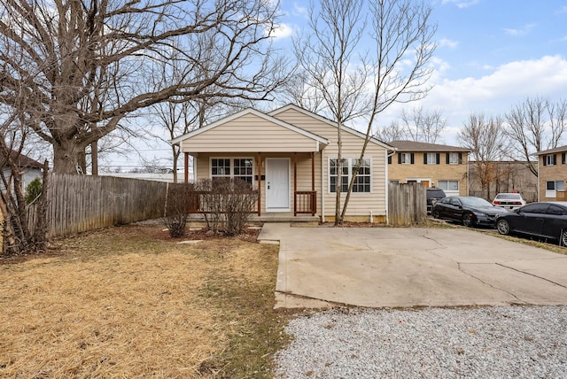 view of front of home with a porch and fence