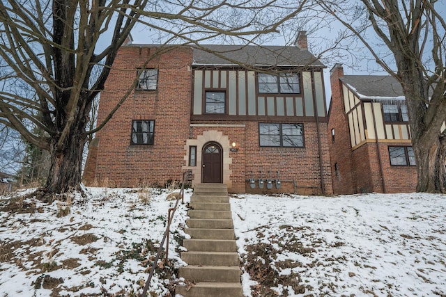 tudor-style house with brick siding