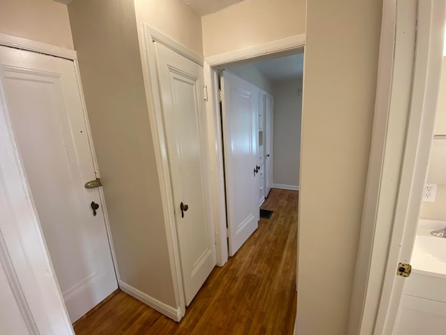 hallway with visible vents and wood finished floors