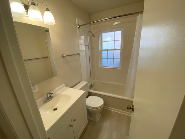 full bathroom featuring shower / bath combination with curtain, wood finished floors, vanity, and toilet