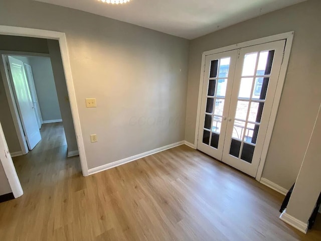 interior space with french doors, light wood-style flooring, and baseboards