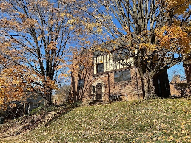 view of front of property with a front lawn and brick siding